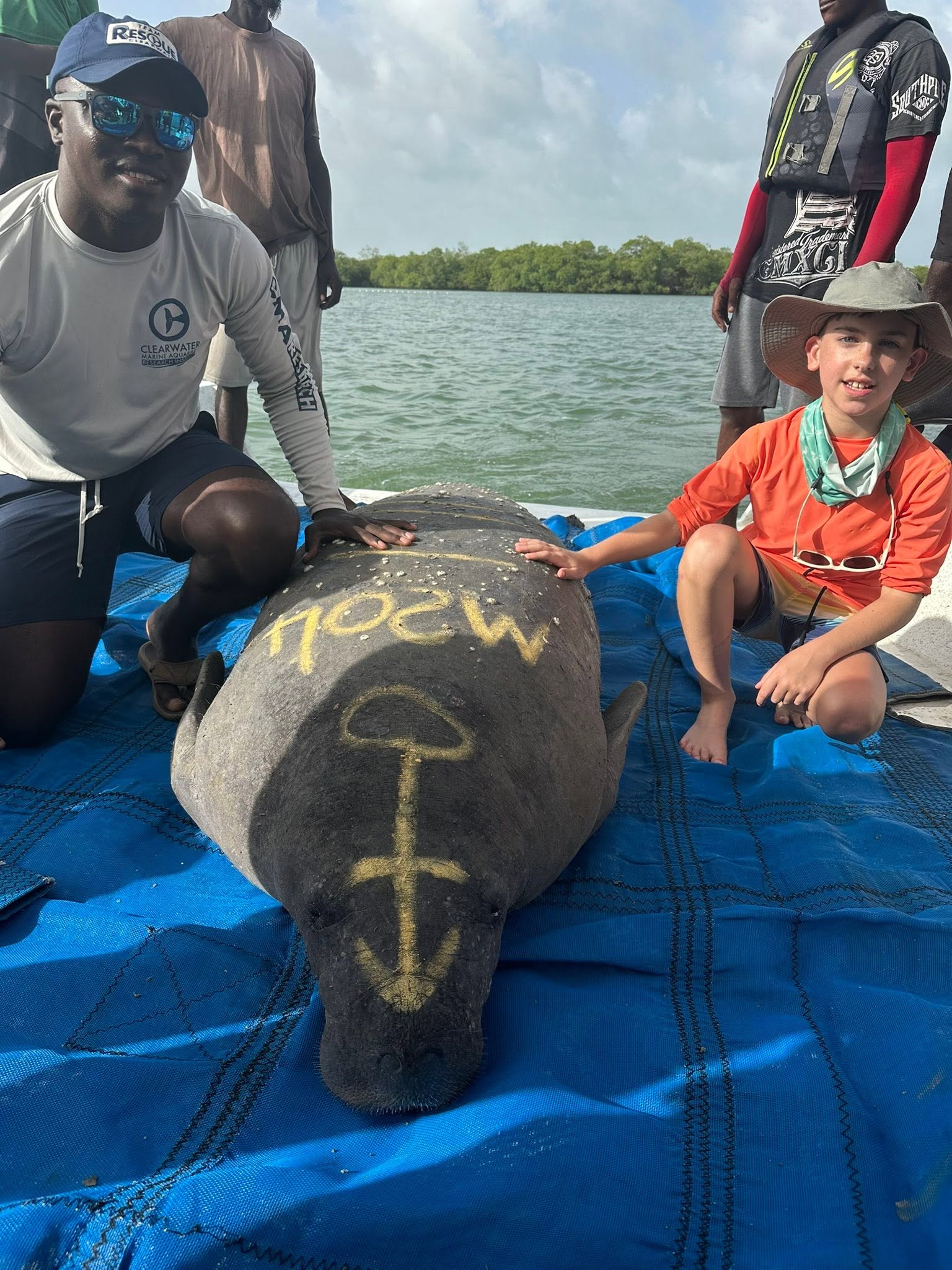 Jacob with Jamal Galves and a manatee during a Belize health assessment