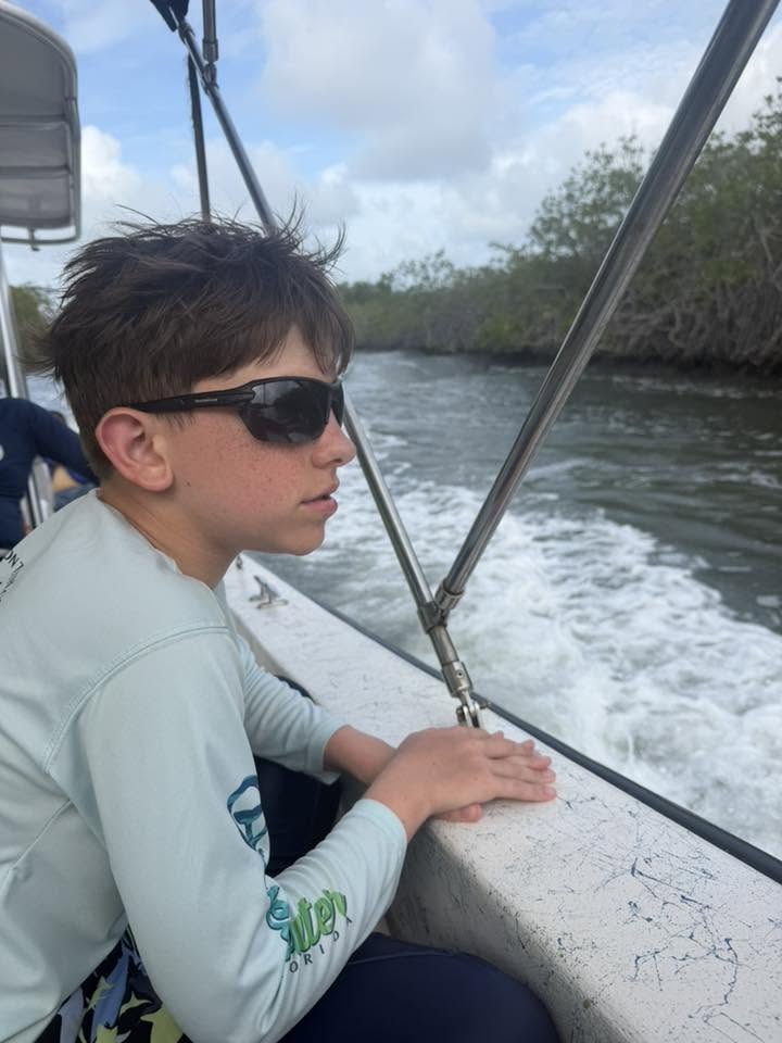 Watching a mangrove channel from the boat during Belize assessments.